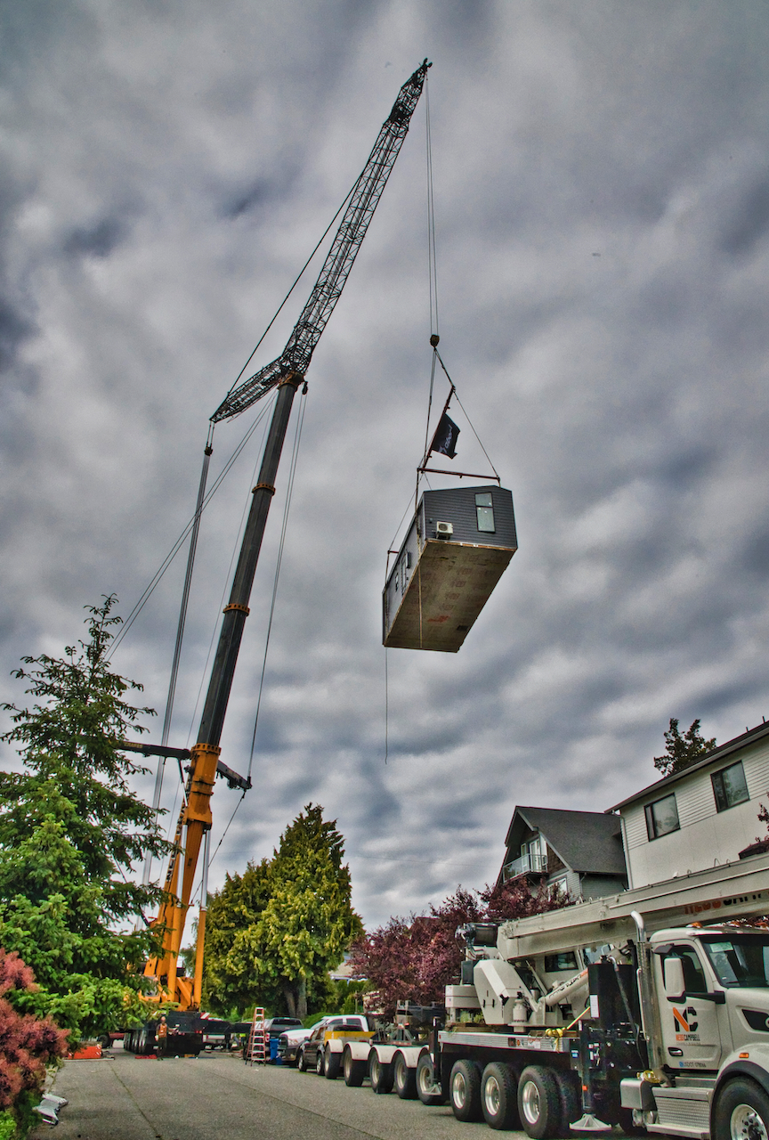 Backyard cottage lifted by crane into Gatewood backyard Westside Seattle